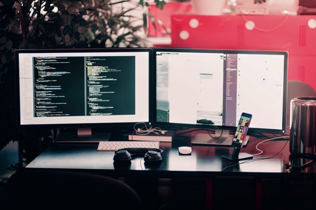Some computer screens on a desk.