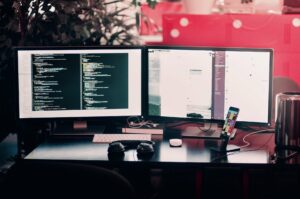 Some computer screens on a desk.