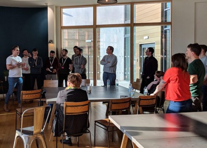 A group of people listening to someone give a talk.